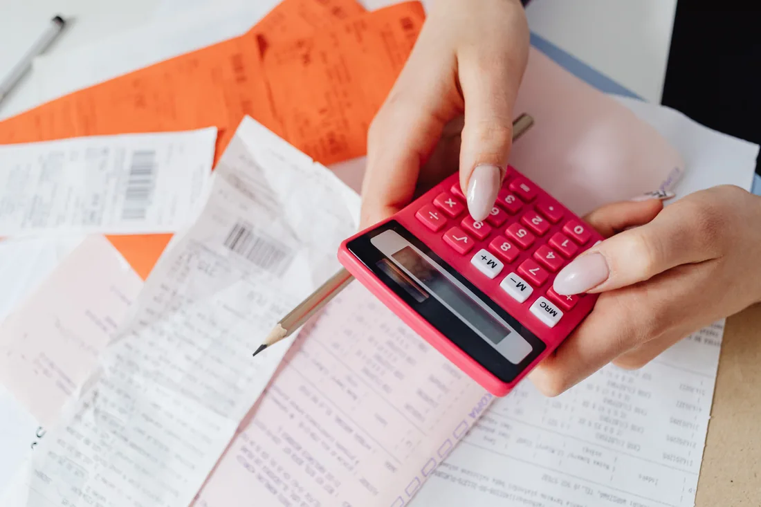 Calculator and paperwork laid out on a desk for working out energy costs