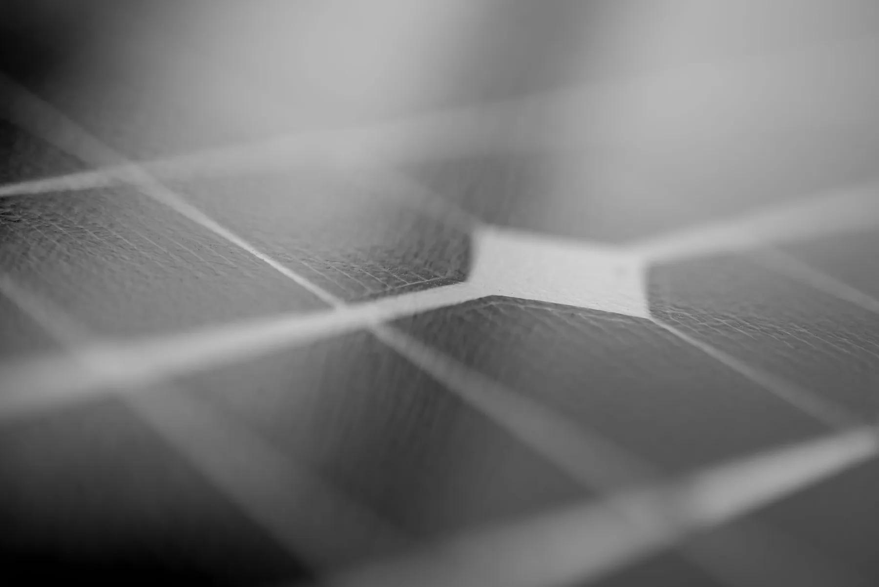 Close-up of solar photovoltaic panel cells against a blue sky