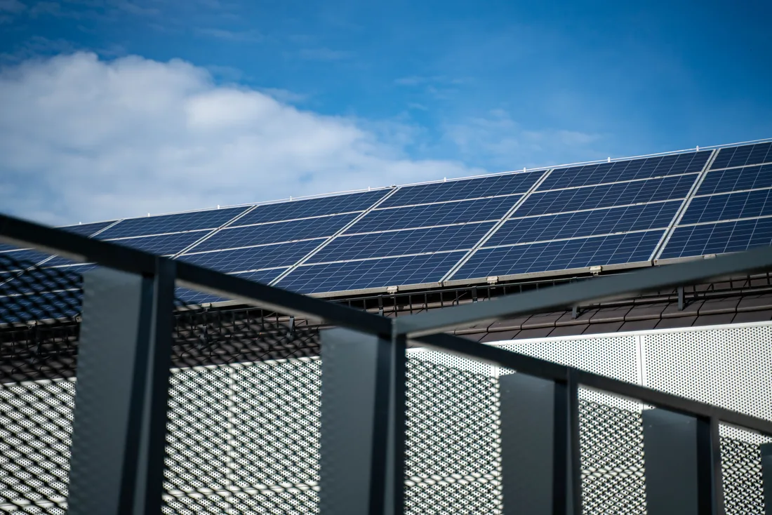 Close view of solar panel mounting rails and clamps fixed to a roof