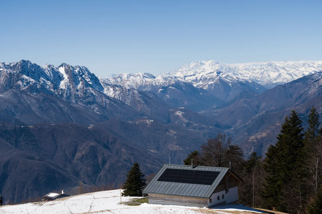 Solar panels on a mountain property with snow on the ground